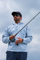 Man wearing a blue mallard camo navigator fleece hoodie