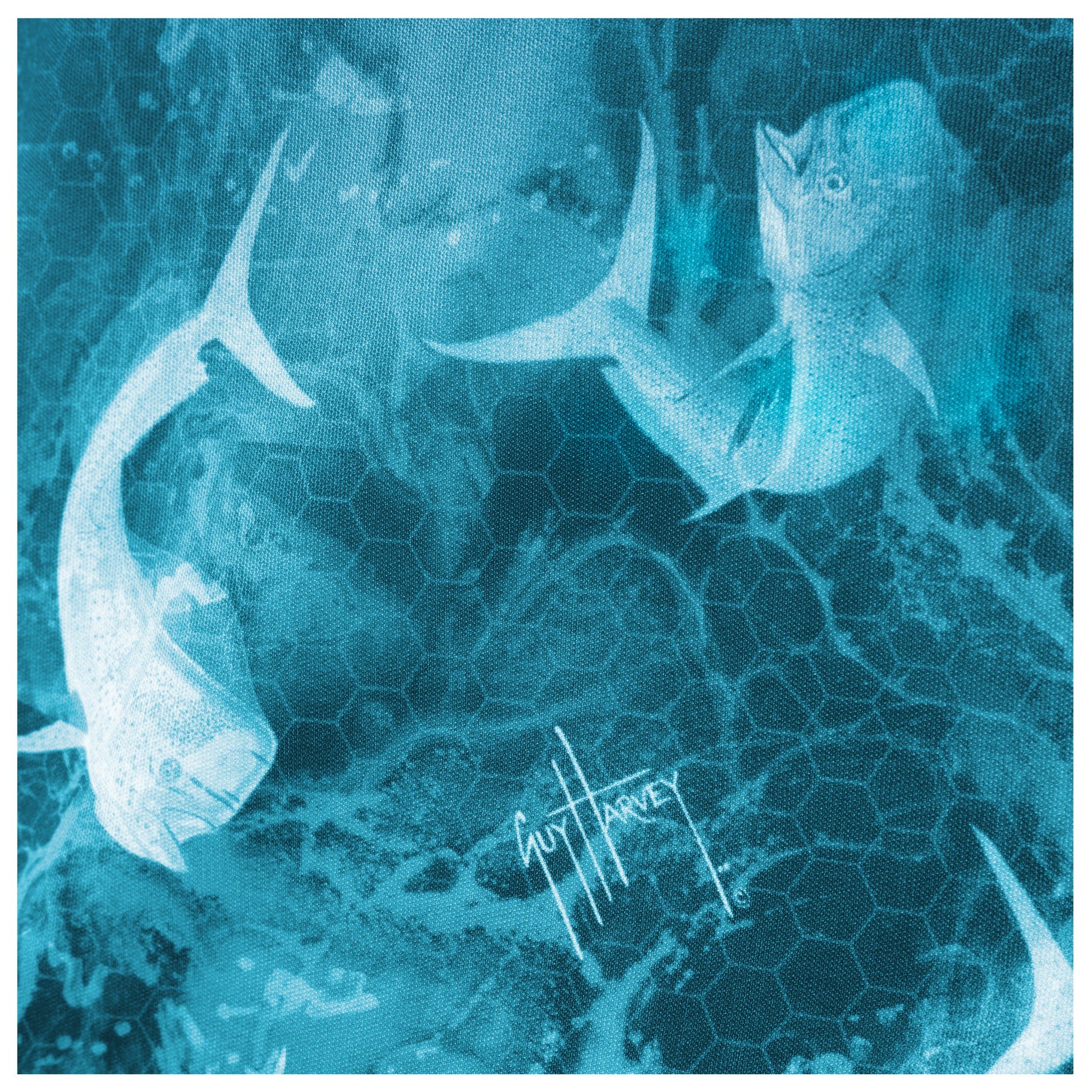 Detailed view of fade blue design with mahi-mahi artwork on back of Guy Harvey Men’s Performance Top