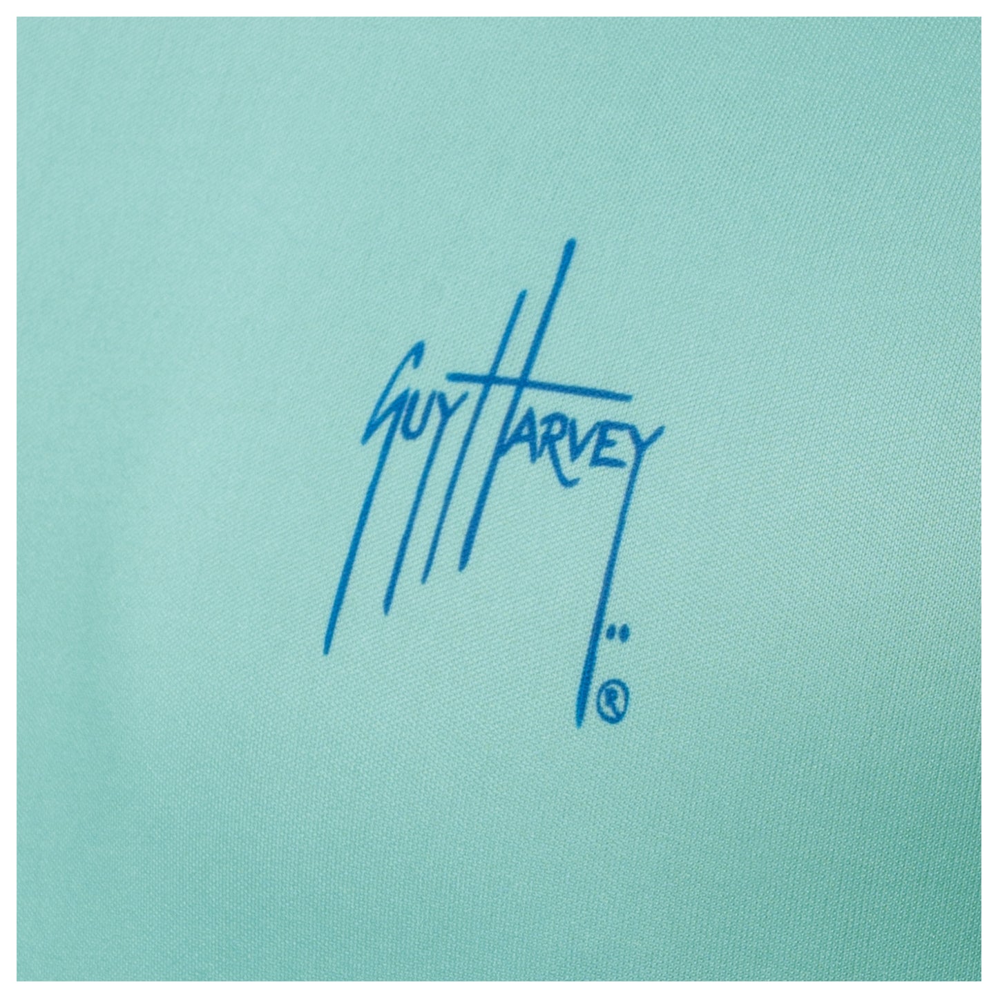 Close-up of chest Guy Harvey signature logo on Men’s Mahi Hex Performance Sun Protection Top