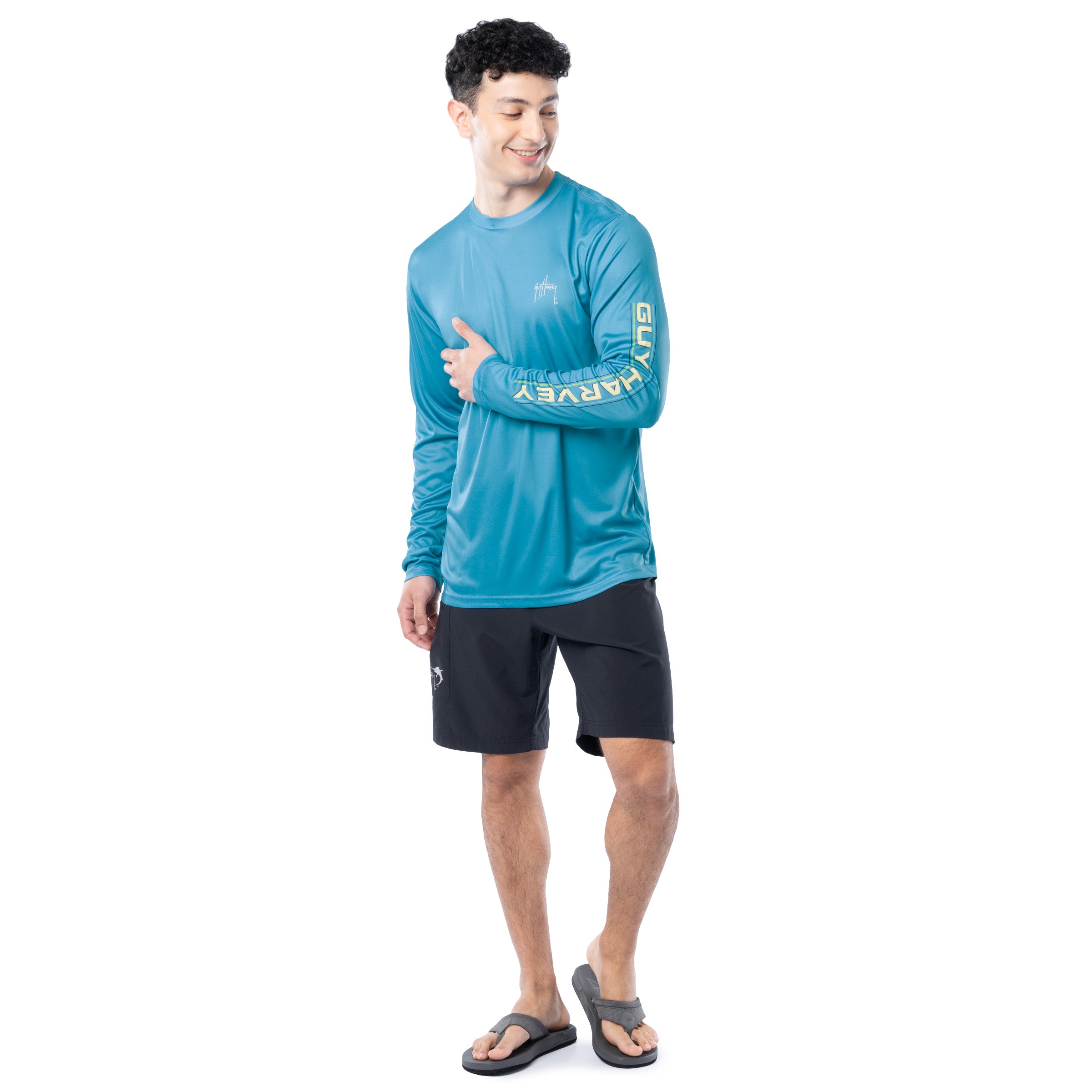 Lifestyle photo of model wearing Guy Harvey Men’s Mahi Shield Performance Sun Protection Long Sleeve Top while fishing
