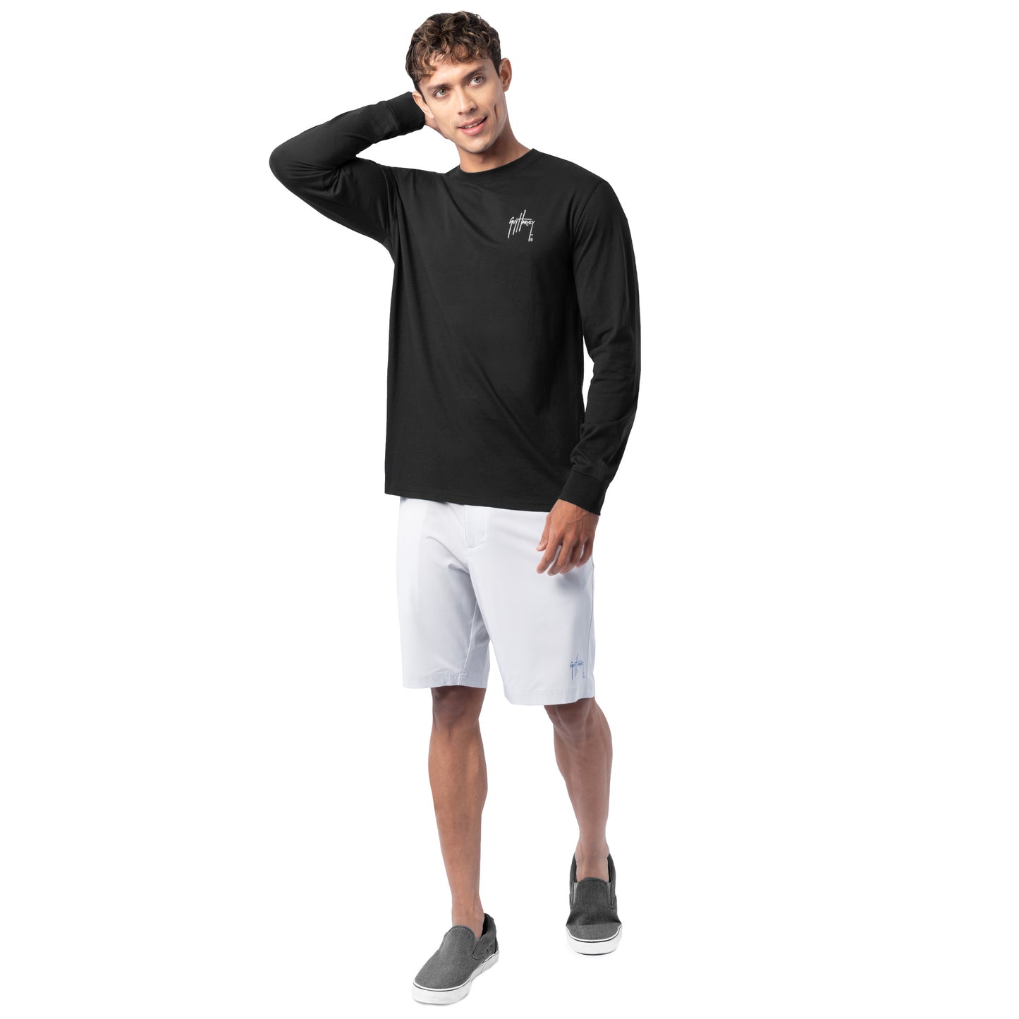 Lifestyle photo of model wearing Guy Harvey Men’s Redfish Tailing Lightweight Long Sleeve Tee on the coast