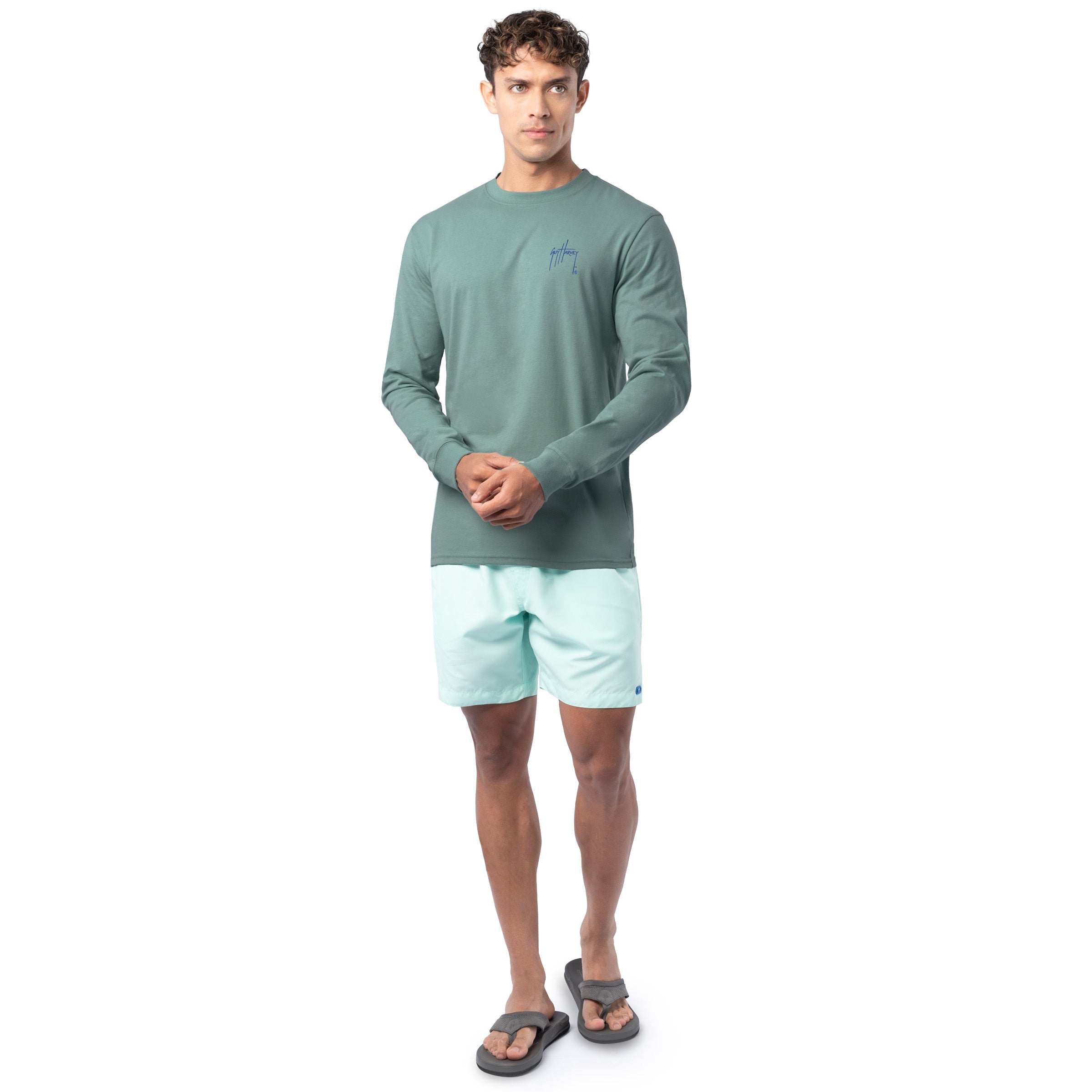Lifestyle photo of model wearing Guy Harvey Men’s Saltwater Paradise Lightweight Long Sleeve Tee near the water