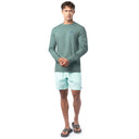 Lifestyle photo of model wearing Guy Harvey Men’s Saltwater Paradise Lightweight Long Sleeve Tee near the water
