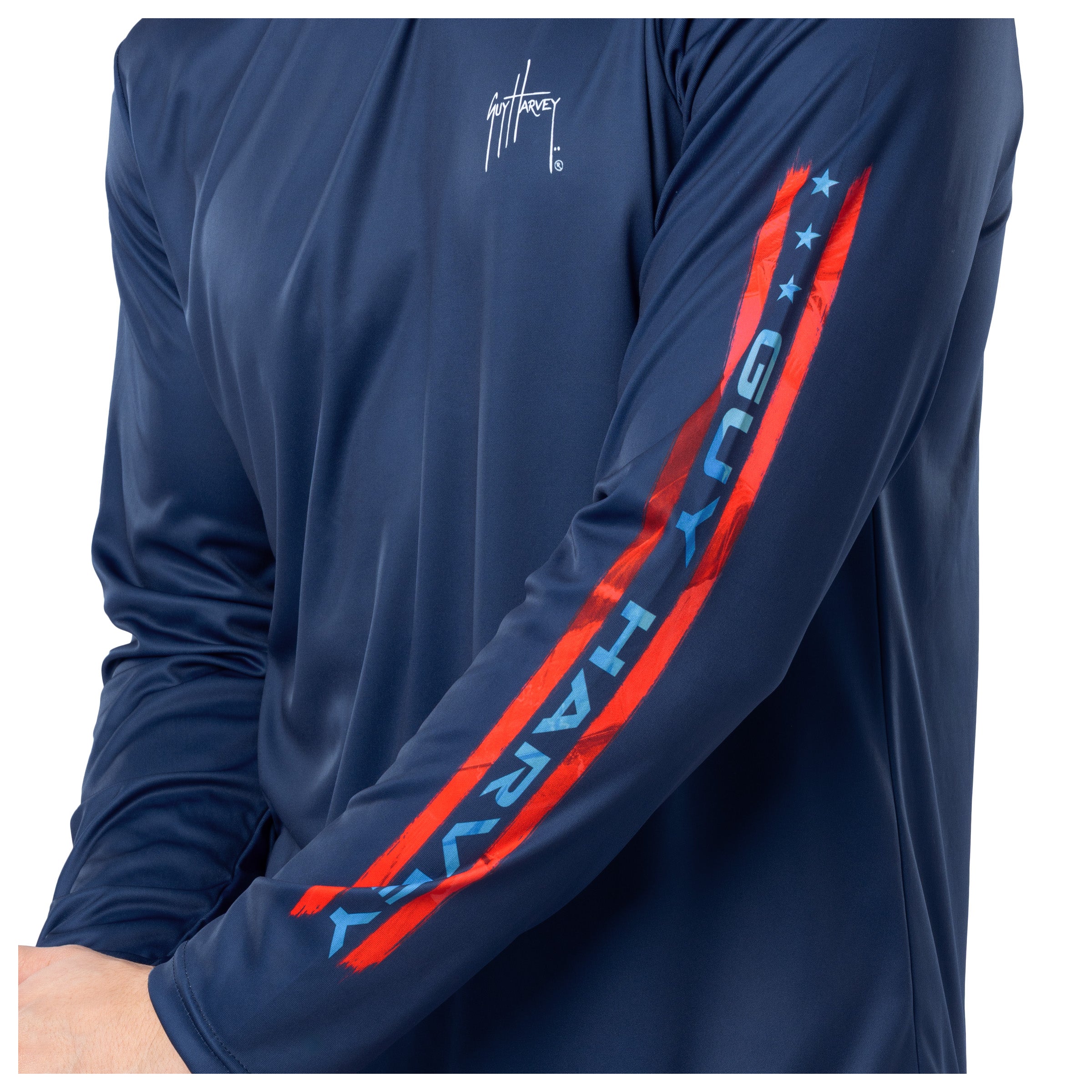 Detail view on the long sleeve showcasing in bold light blue letters "Guy Harvey"