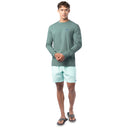 Lifestyle photo of model wearing Guy Harvey Men’s Volcano Lightweight Long Sleeve Tee near the coast