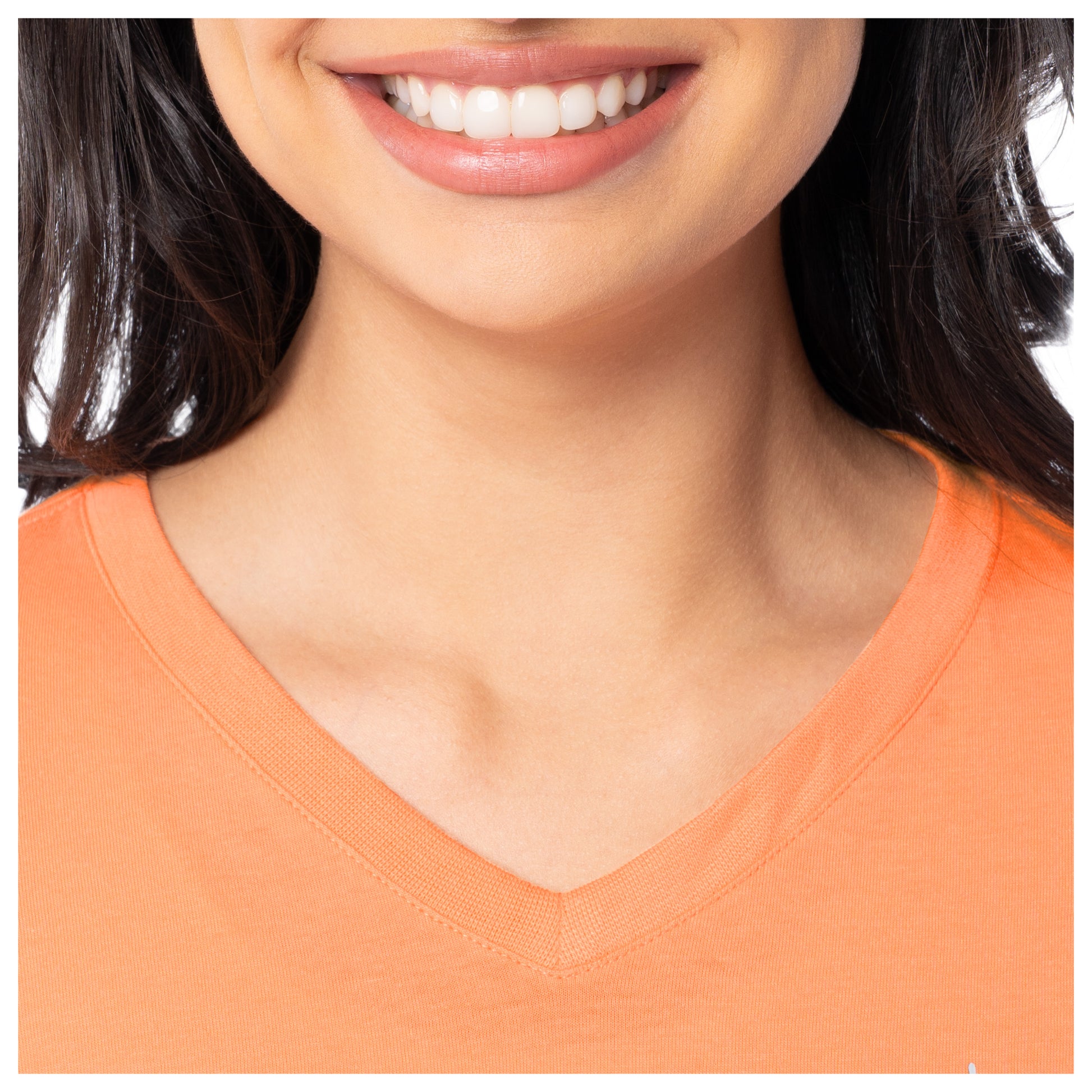 Close-up of a person wearing an orange V-neck shirt with a blurred background