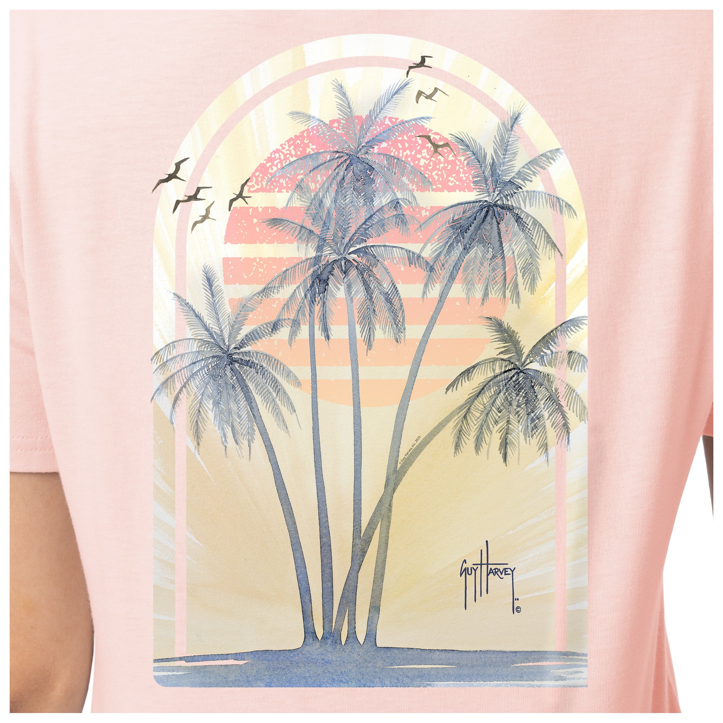 Detailed view of tropical palm tree and sunset artwork on back of Guy Harvey Palm Breeze T-Shirt