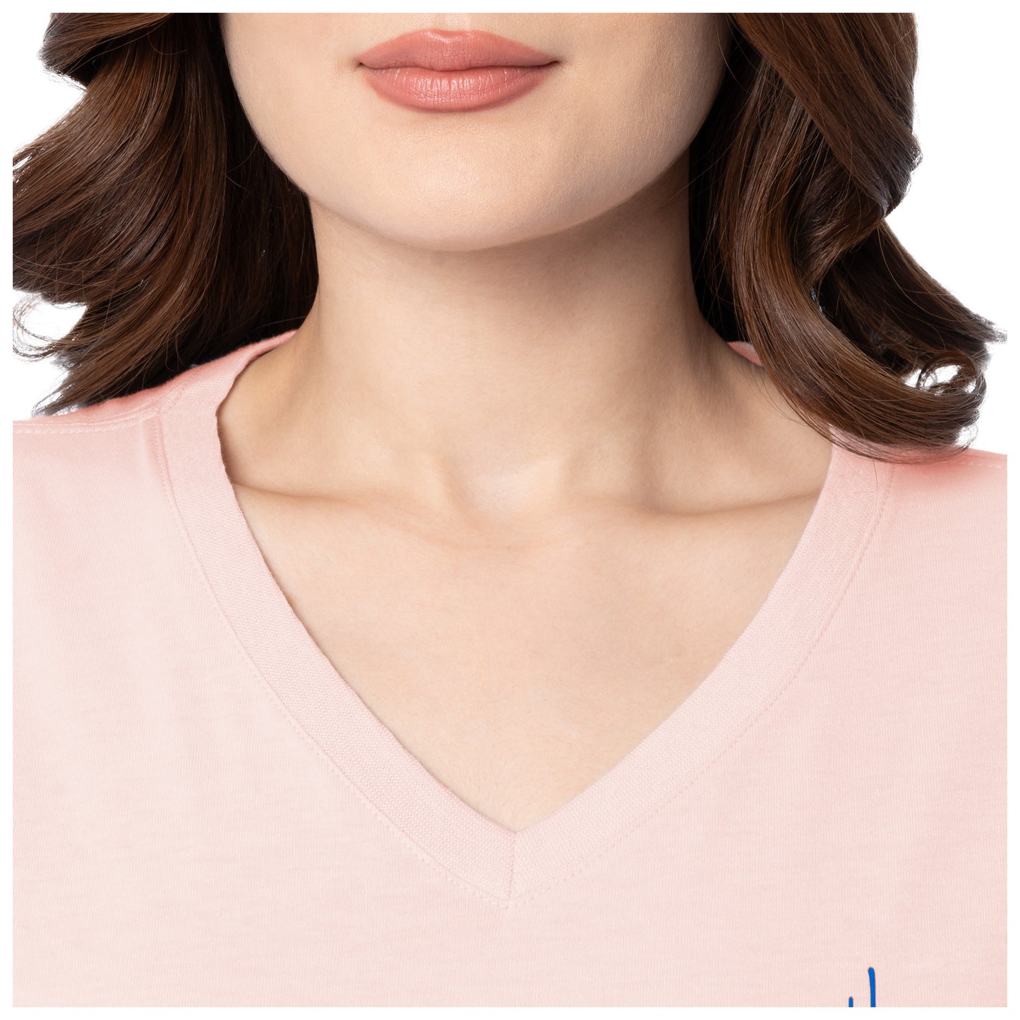 Close-up of a person wearing a pink V-neck top with a neutral background