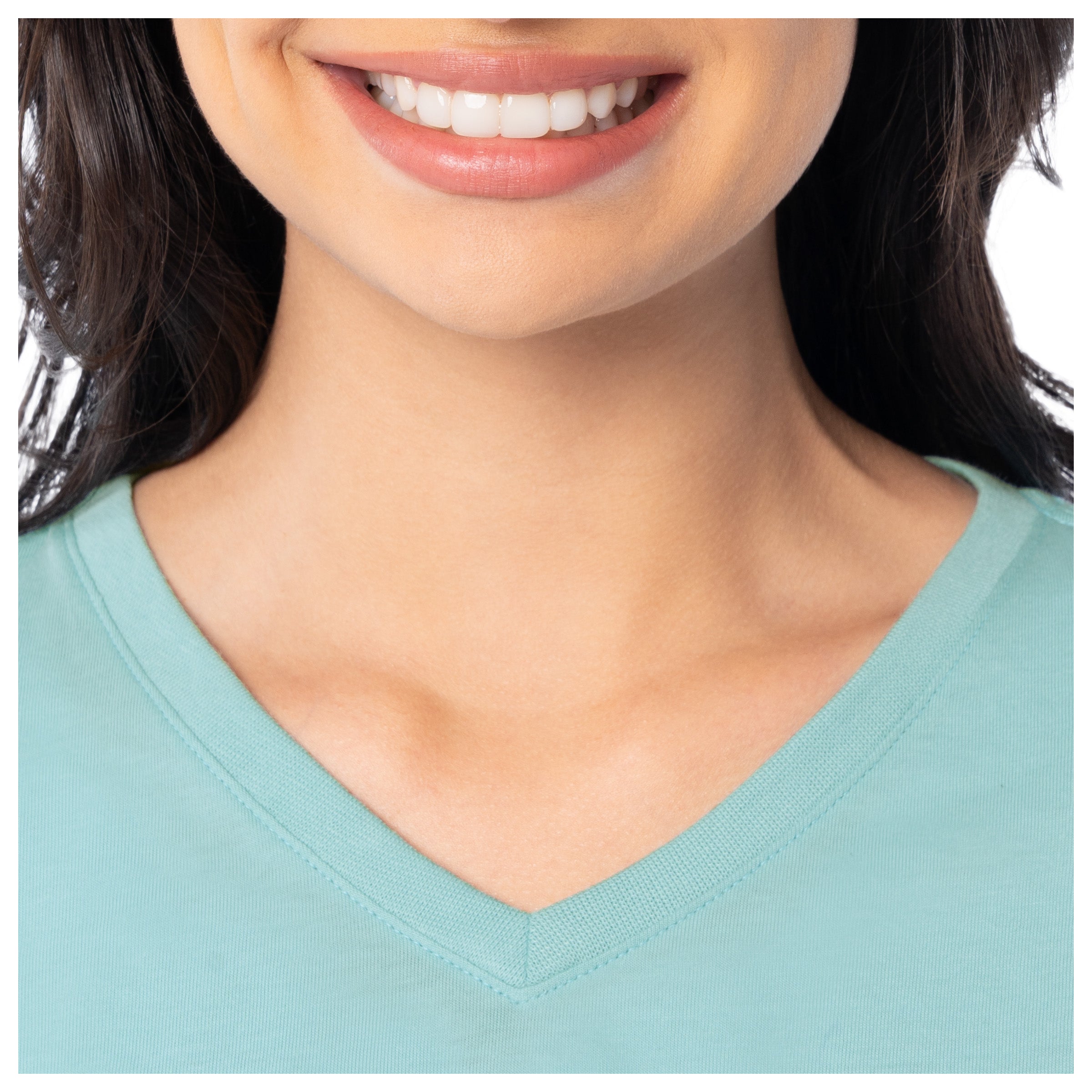 Close-up of a person wearing a light blue V-neck shirt with a neutral background