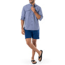 Lifestyle image of long sleeve button down shirt on a man wearing also navy shorts from Guy Harvey
