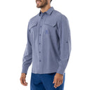 Side view of a man wearing a long sleeve performance fishing shirt with two chest pockets. Left pocket has Guy Harvey art on it.
